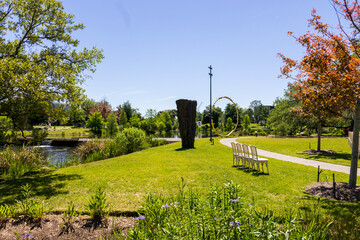 a beautiful spring landscape in the Sculpture Garden at New Orleans City Park with a lake, lush...