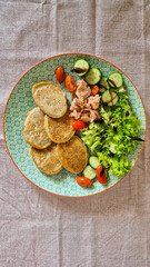 breakfast, oatmeal pancakes, leaf salad, canned tuna, fresh vegetables, no people, top view