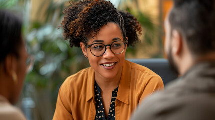 A Biracial woman engaging in a dynamic conversation with two interviewers. - Powered by Adobe