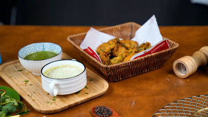 Potato Pakora, Palak Pakora with Green Chutney and Mint chutney on the table