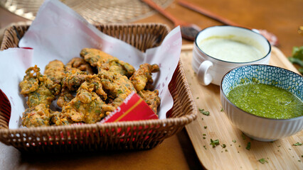 Potato Pakora, Palak Pakora with Green Chutney and Mint chutney on the table
