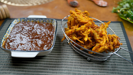Potato Pakora, Palak Pakora with Tamarind Chutney and Potato Ketchup on the table