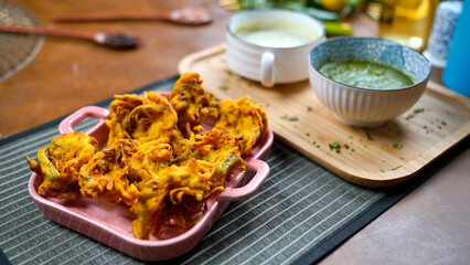 Potato Pakora, Palak Pakora with Green Chutney and Mint chutney on the table