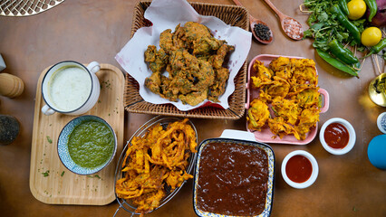 kinds of spices on table, Potato Pakora, Palak Pakora with Tamarind Chutney and Potato Ketchup on...