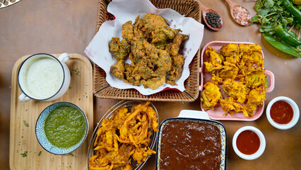 Potato Pakora, Palak Pakora with Tamarind Chutney and Potato Ketchup on the table