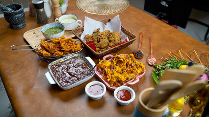 Potato Pakora, Palak Pakora with Tamarind Chutney and Potato Ketchup on the table
