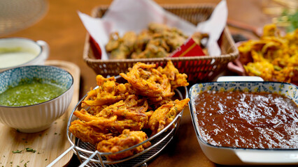 Potato Pakora, Palak Pakora with Tamarind Chutney and Potato Ketchup on the table