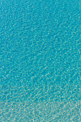 Different types of blue rippling water in a swimming pool with sunshine