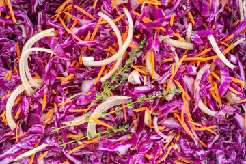Red Cabbage Salad with onion, carrot, thyme. Food background.