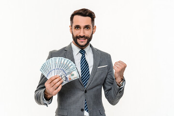 Young Caucasian businessman winning money in lottery isolated over white background. Successful...