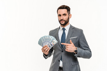 Happy young banker holding huge sum of money isolated over white background. Rich wealthy...