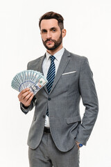 Vertical portrait of extremely rich businessman banker holding dollars isolated over white...