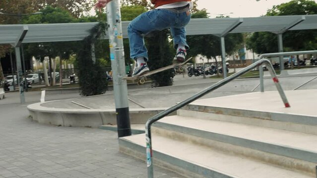 Young skater making 360 flip jump, performing kickflip trick, skateboarder training in skatepark, making tricks, slides and flips, professional extreme sport athlete training ride on skateboard. 