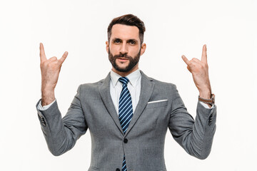 Active young businessman showing rock-n-roll gesture isolated over white background. Cheerful music...