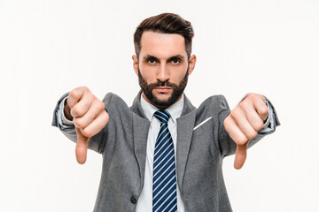 Angry young businessman showing thumbs down isolated over white background. Caucasian man manager...