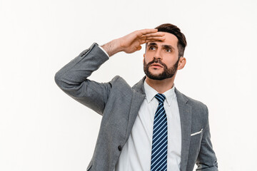 Successful young businessman looking far away for career ladder isolated over white background. Manager banker ceo boss looking for new opportunities, promotion, startup