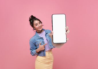 Beautiful Asian woman showing and pointing finger to smartphone mockup of blank screen isolated on...