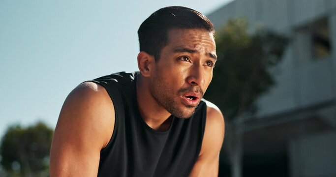Breathing, exercise and man outdoor in city for fitness, break and energy in morning for challenge in cardio. Tired, runner and person relax after healthy workout or thinking of training with pride