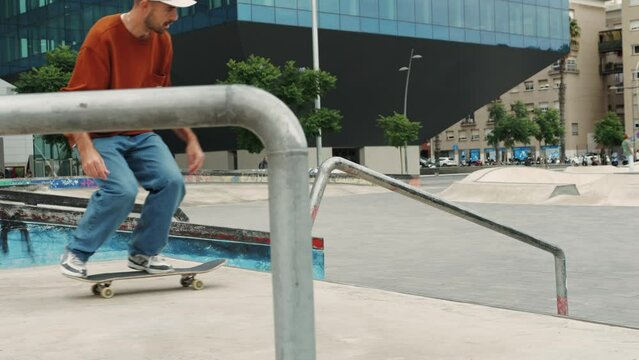 Young skater making 360 flip jump, performing kickflip trick, skateboarder training in skatepark, making tricks, slides and flips, professional extreme sport athlete training ride on skateboard. 