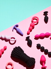 Sex toys background. anal plugs and dildo over pink backdrop - obrazy, fototapety, plakaty