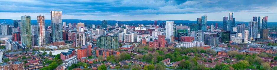 Panoramic aerial view of Manchester and Salford Skyline with a cloudy sky 