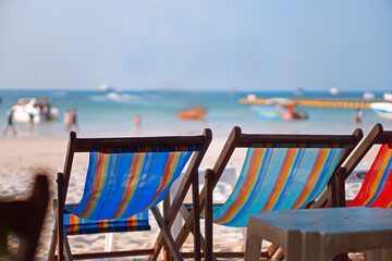 A canvas bed on the beach  Looking ahead is the sandy beach and the sea and the blue sky.