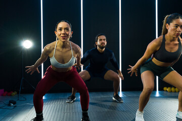 Dynamic group of people exercising and recording a fitness class