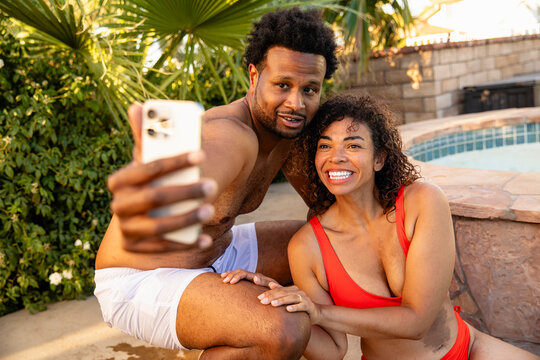 Two Adults Video Chat On The Phone From Poolside