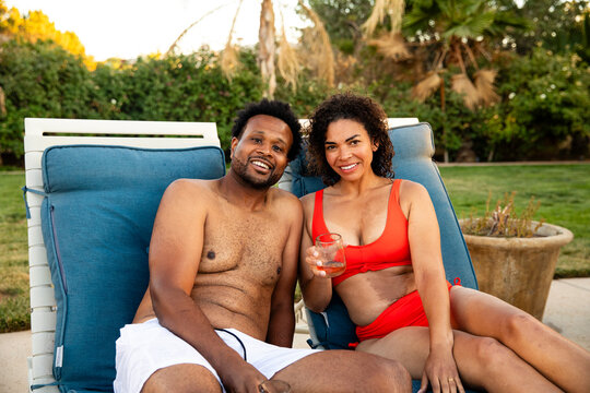 Beautiful Couple Smiles At The Camera Poolside