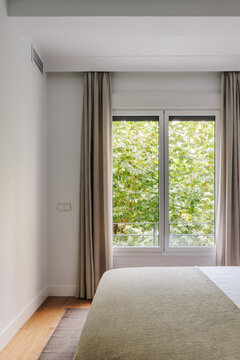 Modern bedroom with large window that lets in plenty of natural light