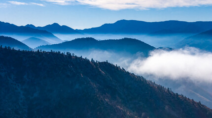 Beautiful mountain scenery on the background of clouds, layers of mountains on the horizon, Sierra...