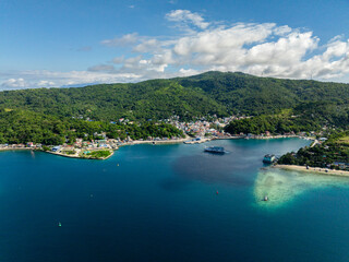 Fototapeta premium Modern buildings in town city at coastline in Romblon Island. Romblon, Philippines.