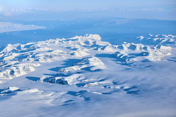 Aerial view of the Greenland with mountains and ocean bay during the flight from Europe to the...