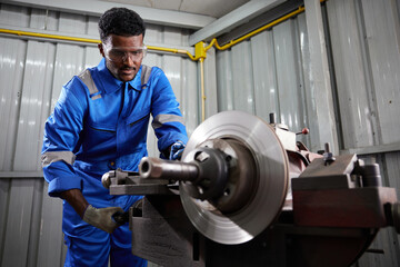 factory worker or technician working and control lathe machine in factory