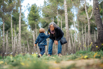 Grandson shows a flower to his grandmother