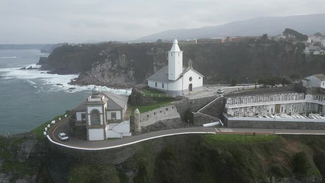 Aerial view of Luarca lighthouse and church against sea