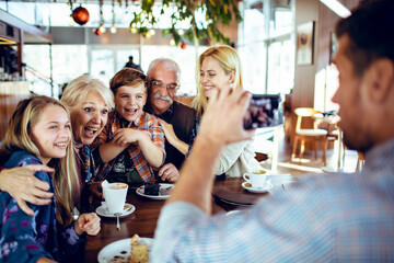 Family photo being taken at a cafe