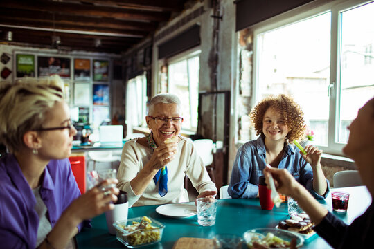 Diverse group of women of different age eating lunch at office