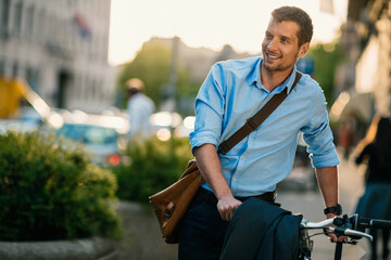 Active businessman riding bicycle in city street
