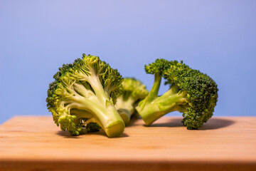 freshly cut broccoli on a wooden cutting board