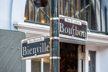 Street signs on the corner of Bourbon Street and Bienville Street in the French Quarters in New Orleans Louisiana USA