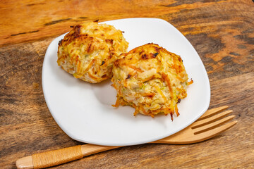 Chicken Vegetables Cutlets on white platter over wooden background..