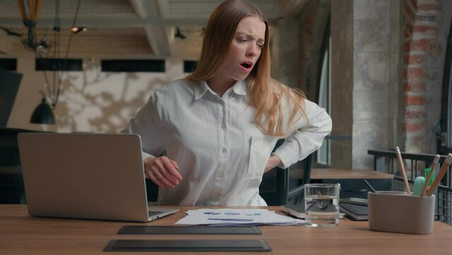 Business work office table laptop computer Caucasian businesswoman girl female business woman at desk suffer discomfort lower neck pain osteochondrosis health problem discomfort sitting ache backache