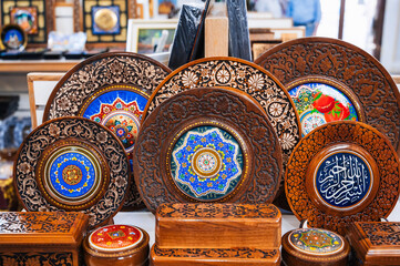 handmade Uzbek wooden gift plates and caskets with wood carvings in the souvenir shop of Uzbekistan...