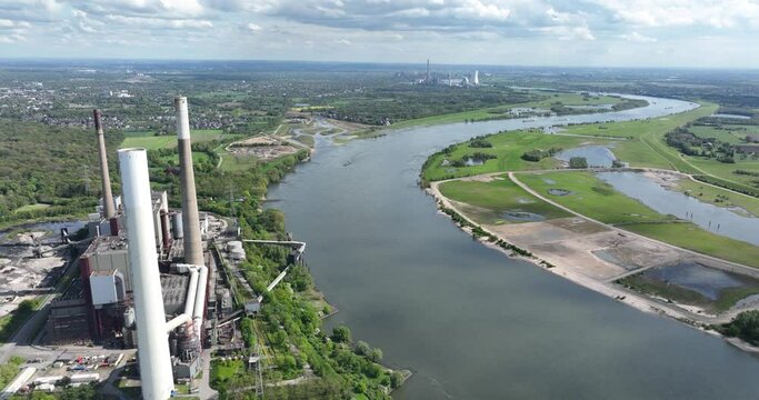 The Ruhr area is a highly industrialized region in the German state of North Rhine Westphalia. Here we see the rhine river and industrial powerplant. important places are Duisburg , Essen , Bochum