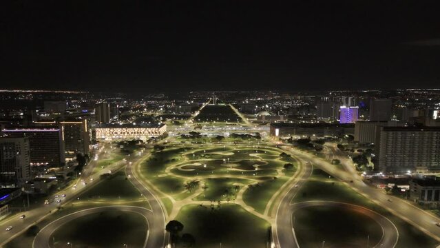 Drone slowly ascends over Jardim Burle Marx facing away from TV Tower in Brasilia, Brazil