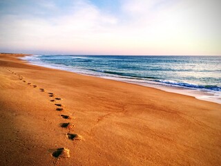 Footprints on the beach during sunset near Faro, Portugal, December 2018
