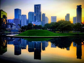 Kuala Lumpur city skyline reflected in the pond of KLCC park, Kuala Lumpur, Malaysia, March 2019