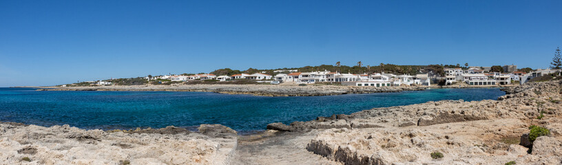 Panoramic photograph of the Biniancolla cove on the island of Menorca, offering a picturesque...