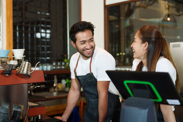 A business couple owns small cafe. Young Asian business women both stand smile with men of...